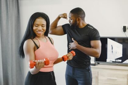 "Young couple doing bicep curls with dumbbells at home - home bicep workout"