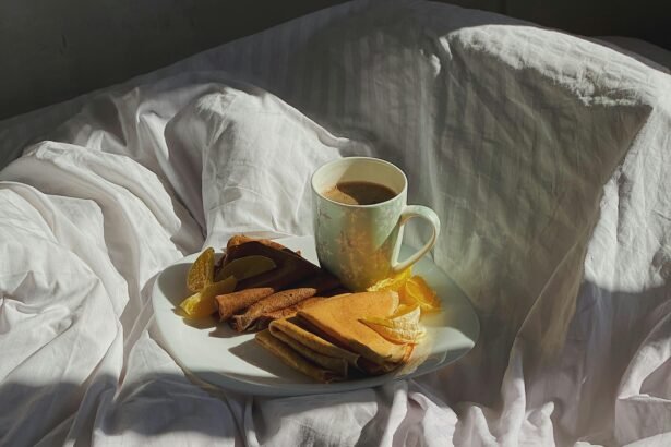 A healthy breakfast in bed with fruit pancakes on white sheets, perfect for people who hate cooking and looking for lazy meal ideas