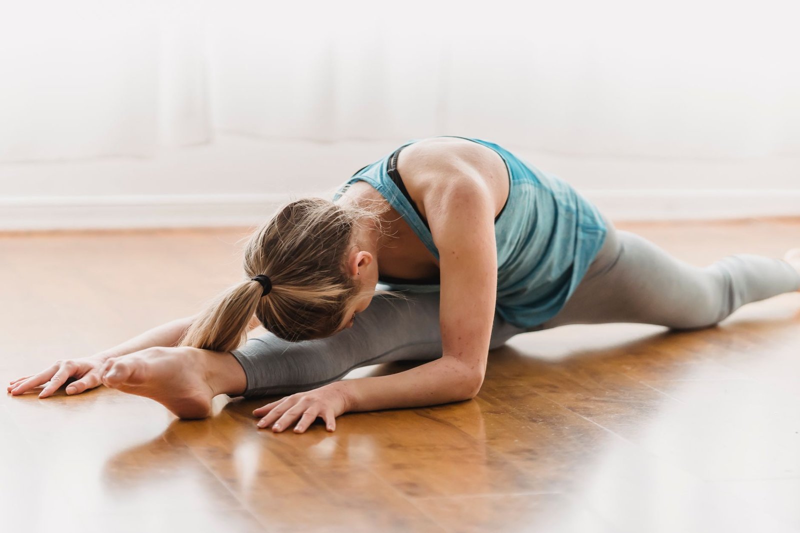 Woman performing gentle core and spine stretches on a yoga mat.