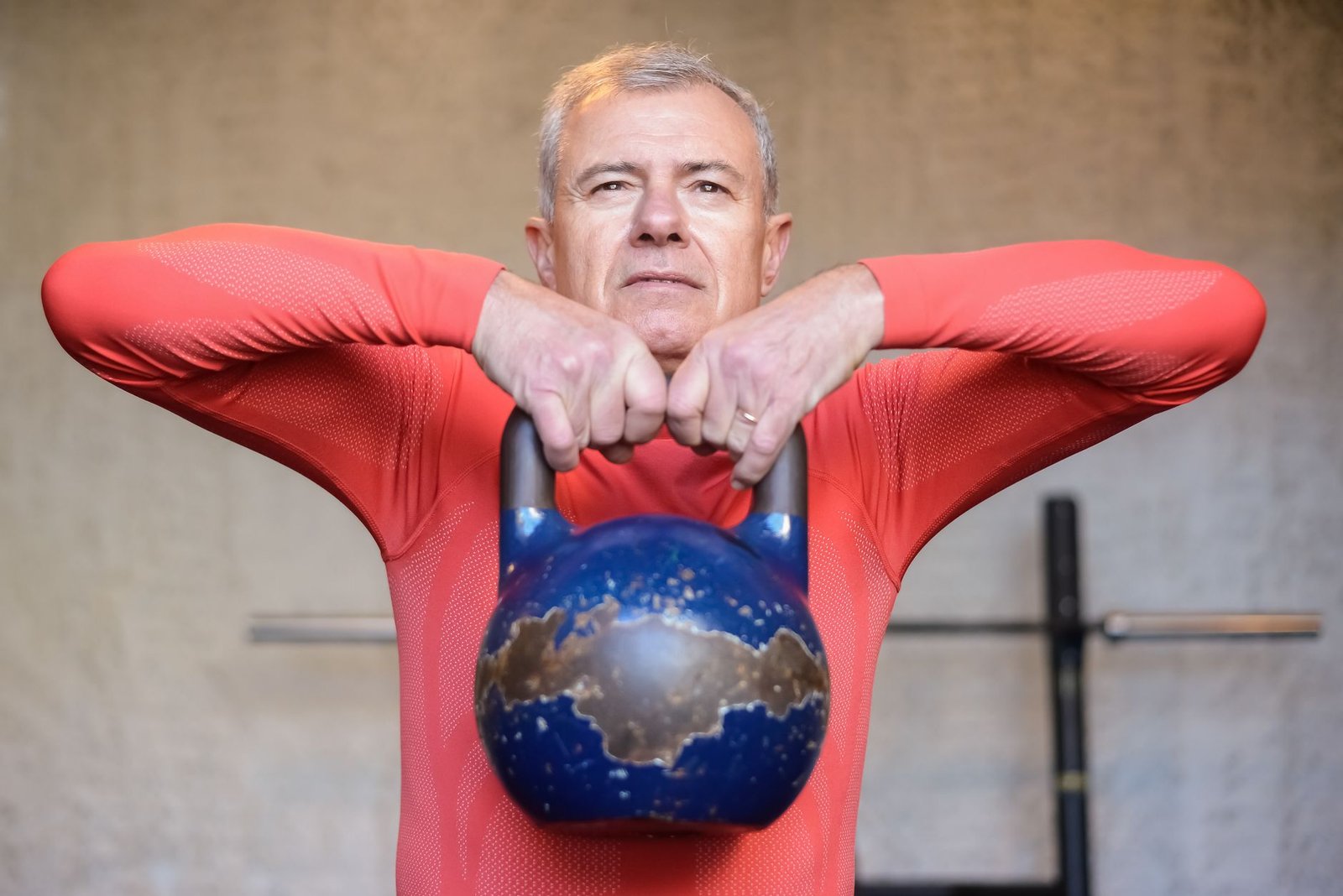 Senior adult engaging in safe, progressive resistance training to stimulate neuromuscular adaptation.