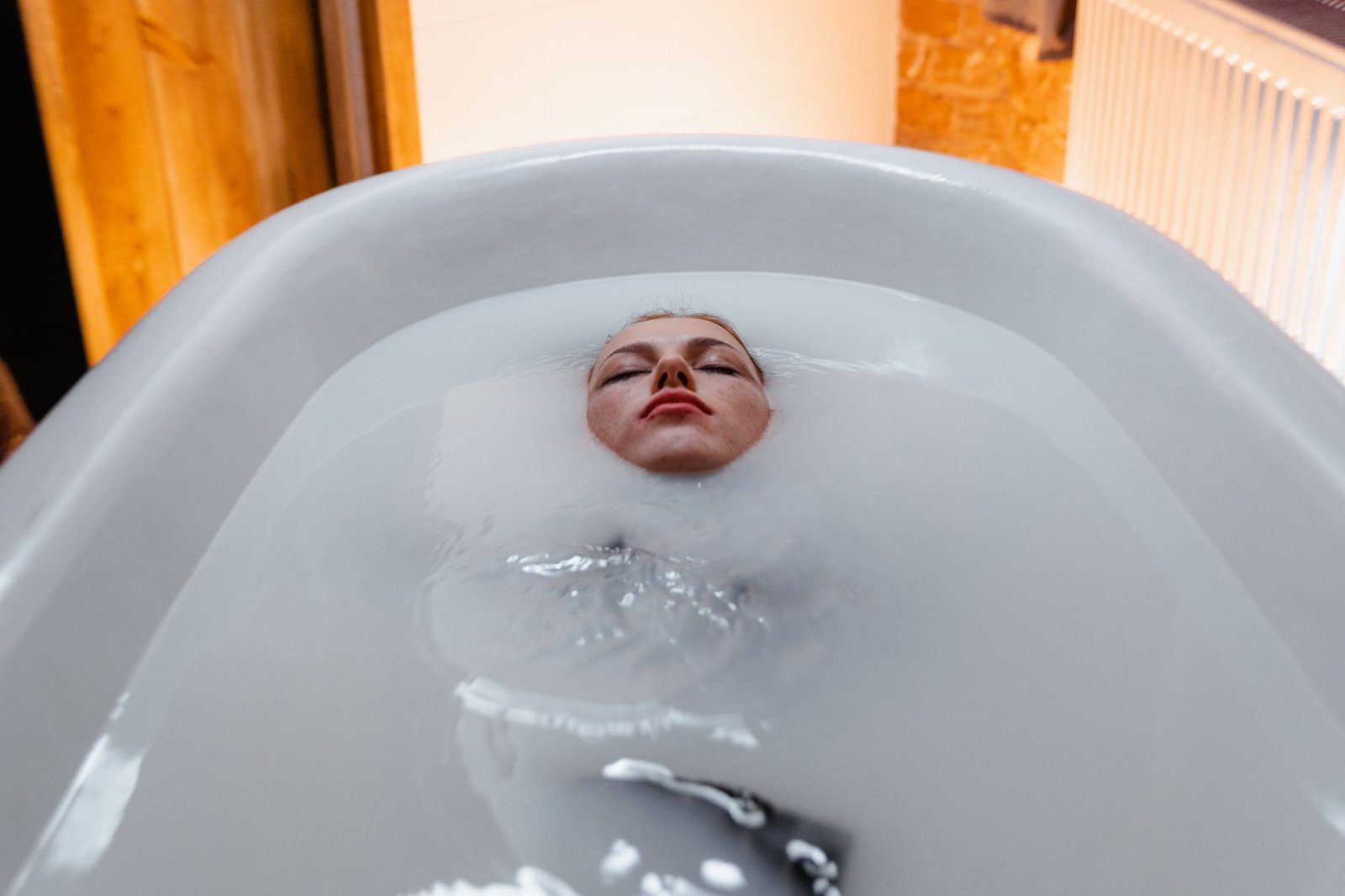 Focused individual practicing controlled breathing during a cold water immersion session.