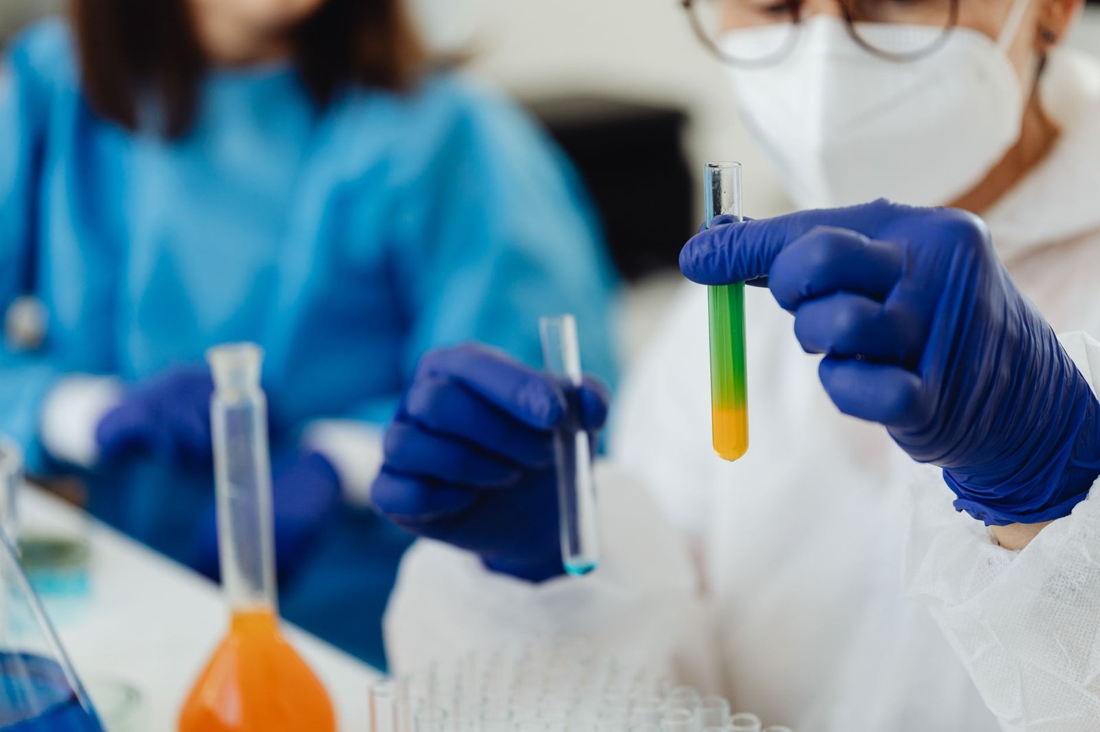 Laboratory technician pipetting blood serum samples into testing vials.