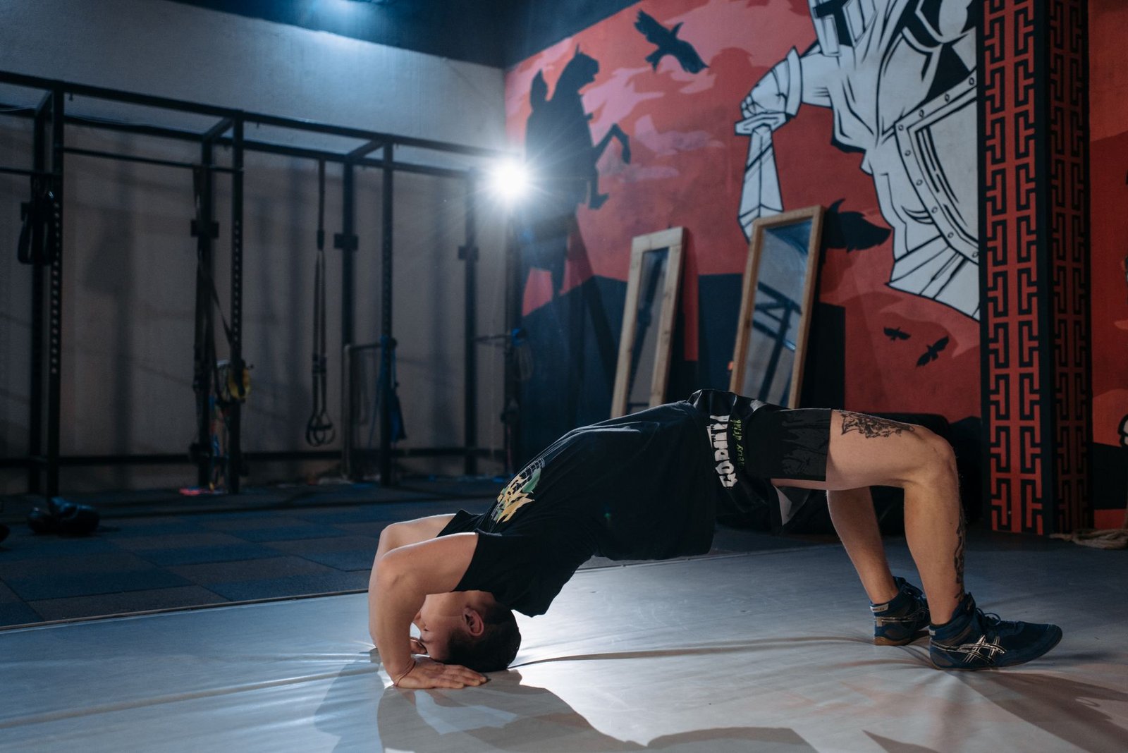 Athlete performing a supine wall glute bridge with proper pelvis alignment.