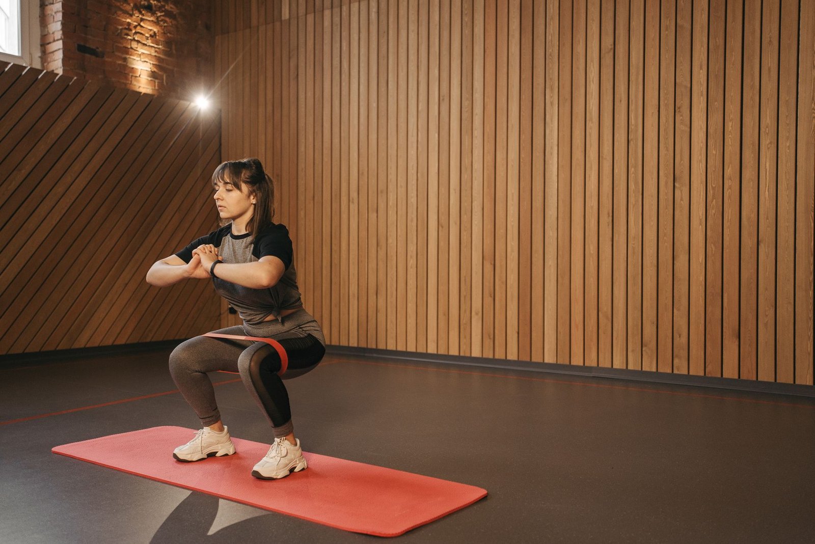 Isometric wall slide with back and arms maintaining controlled vertical alignment.