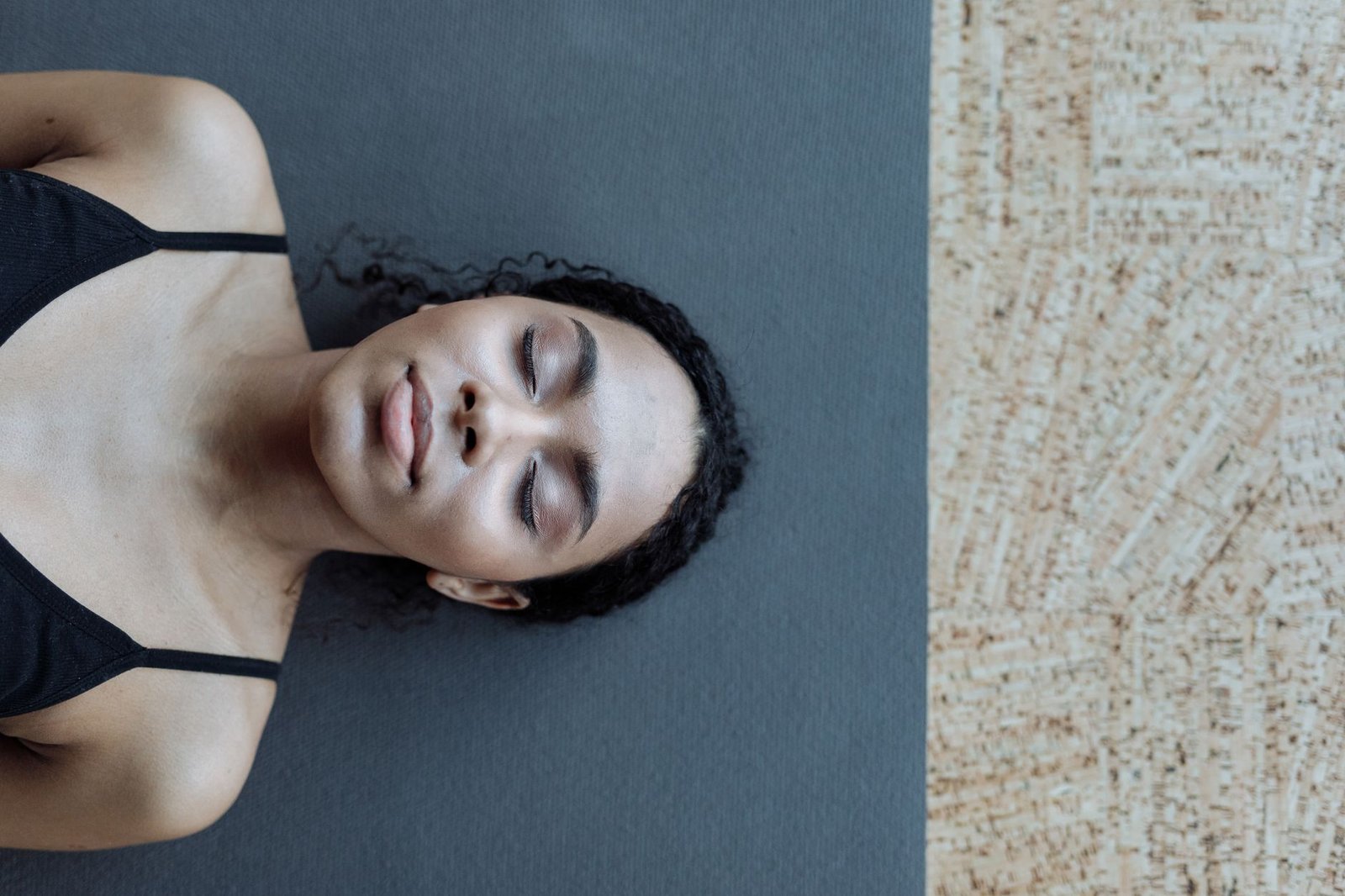 Woman relaxing in quiet room after completing somatic stress relief routine.